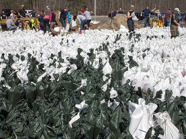 Volunteers at the Constance Bay Community Centre get busy filling sandbags and using them to protect their homes in anticipation of rising water from the Ottawa River.