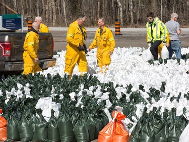 Volunteers at the Constance Bay Community Centre get busy filling sandbags and using them to protect their homes in anticipation of rising water from the Ottawa River.