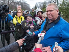 Premier Doug Ford meets with the media in Constance Bay on the Ottawa River as he came to assess the flood damage.