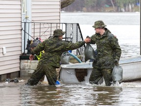 Canadian military personnel are hard at work along Bayview Drive as 1RCR from Petawawa begins assisting with sandbagging in Constance Bay on Friday, April 26, 2019.
