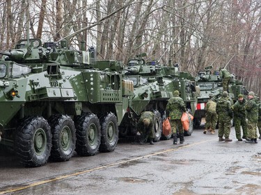 Light armoured vehicles are parked along Bayview Dr as 1RCR from Petawawa beginning assisting with sandbagging in Constance Bay.
