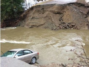 A vehicle is seen in a gaping hole in the road in the Municipality of Pontiac, about 30 km northwest of Ottawa in this photo posted on the Twitter page of MRC des Collines-de-l'Outaouais. One person has died amid flooding in western Quebec, after rising river levels swept away part of a road in the Outaouais region overnight. Police confirmed the death in a tweet Saturday morning, posting a photo of a gaping hole along the road in the Municipality of Pontiac, about 30 km northwest of Ottawa.