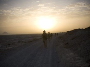In this photo taken Saturday, Sept. 11, 2010, Canadian soldiers with the 1st RCR Battle Group, The Royal Canadian Regiment, patrol in the early morning outside Salavat, southwest of Kandahar, Afghanistan.