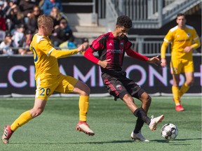 Ottawa Fury FC player Wal Fall (8) tries to protect the ball from defensive pressure by Matt LaGrassa (20) of Nashville Soccer Club during a United Soccer League Championship match at TD Place Stadium on April 6, 2019. Nashville won 3-0.