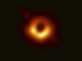 This image released Wednesday, April 10, 2019, by Event Horizon Telescope shows a black hole. Scientists revealed the first image ever made of a black hole after assembling data gathered by a network of radio telescopes around the world. (Event Horizon Telescope Collaboration/Maunakea Observatories via AP) ORG XMIT: NY301