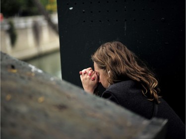 A woman sits in despair near the Notre Dame cathedral after the fire in Paris, Tuesday, April 16, 2019. A catastrophic fire engulfed the upper reaches of Paris' soaring Notre Dame Cathedral as it was undergoing renovations Monday, threatening one of the greatest architectural treasures of the Western world as tourists and Parisians looked on aghast from the streets below.