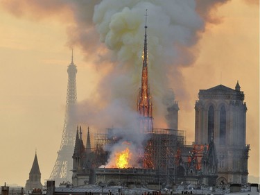 In this image made available on Tuesday April 16, 2019 flames and smoke rise from the blaze at Notre Dame cathedral in Paris, Monday, April 15, 2019. An inferno that raged through Notre Dame Cathedral for more than 12 hours destroyed its spire and its roof but spared its twin medieval bell towers, and a frantic rescue effort saved the monument's "most precious treasures," including the Crown of Thorns purportedly worn by Jesus, officials said Tuesday.
