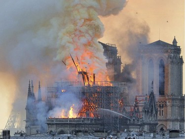 In this image made available on Tuesday April 16, 2019 flames and smoke rise from the blaze after the spire toppled over on Notre Dame cathedral in Paris, Monday, April 15, 2019. An inferno that raged through Notre Dame Cathedral for more than 12 hours destroyed its spire and its roof but spared its twin medieval bell towers, and a frantic rescue effort saved the monument's "most precious treasures," including the Crown of Thorns purportedly worn by Jesus, officials said Tuesday.