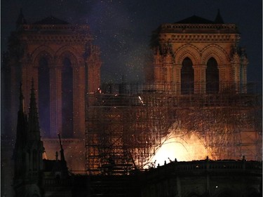 Notre Dame cathedral is burning in Paris, Monday, April 15, 2019. A catastrophic fire engulfed the upper reaches of Paris' soaring Notre Dame Cathedral as it was undergoing renovations Monday, threatening one of the greatest architectural treasures of the Western world as tourists and Parisians looked on aghast from the streets below.