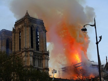 Firefighters use hoses as Notre Dame cathedral burns in Paris, Monday, April 15, 2019. A catastrophic fire engulfed the upper reaches of Paris' soaring Notre Dame Cathedral as it was undergoing renovations Monday, threatening one of the greatest architectural treasures of the Western world as tourists and Parisians looked on aghast from the streets below.