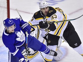 Boston Bruins defenceman Zdeno Chara (33) checks Toronto Maple Leafs left wing Zach Hyman (11) during first period NHL playoff hockey action in Toronto, on Monday, April 15, 2019.