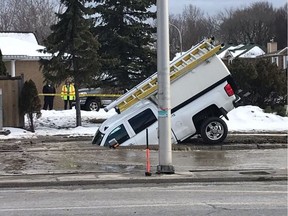 A Good Samaritan who stopped to help a woman in an overturned car on Jeanne d’Arc Boulevard watched in dismay as his truck sank into a hole that opened when a broken fire hydrant gushed water onto the street.