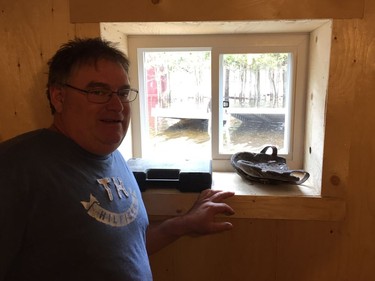 Bill Fisher peers at water outside his basement window on the north shore of Dalhousie Lake on Saturday, April 27, 2019.