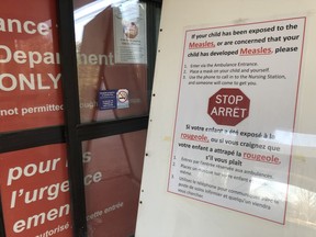 A sign at the Children's Hospital of Eastern Ontario (CHEO) emergency entrance giving instructions to parents if their child has been exposed or has developed measles on April 4, 2019. Errol McGihon/Postmedia