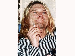 FILE - This 1993 file photo shows Kurt Cobain, the lead singer of the US rock band Nirvana. On Friday, April 5, 2019, people gathered throughout the day at Viretta Parkin in Seattle, leaving flowers, candles and written messages on the 25th anniversary of Cobain's death. Cobain, whose band Nirvana rose to global fame amid Seattle's grunge rock years of the early 1990s, shot himself on April 5, 1994 in his home near Lake Washington.