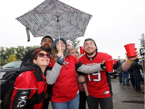 Fans enjoy their drinks during a tailgate party at McMahon stadium in Calgary in September.