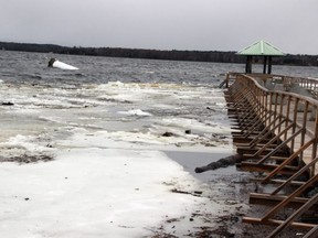 Floodwaters wash over a landmark lighthouse that was toppled in Pembroke late Friday.