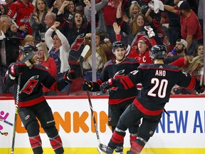 Carolina Hurricanes' Teuvo Teravainen (86) of Finland, celebrates his goal against the Washington Capitals with teammates Sebastian Aho (20) of Finland, and Jaccob Slavin (74) during the second period of Game 4 of an NHL hockey first-round playoff series in Raleigh, N.C, Thursday, April 18, 2019. The Hurricanes won 2-1 to tie the series at 2-2.