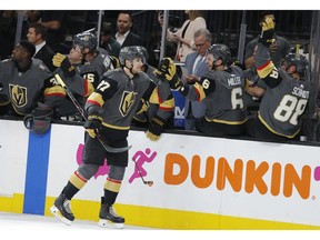Vegas Golden Knights defenseman Shea Theodore (27) is congratulated after scoring against the San Jose Sharks during the first period of Game 4 of a first-round NHL hockey playoff series Tuesday, April 16, 2019, in Las Vegas.