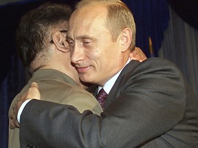 FILE - In this Aug. 23, 2002, file photo, Russian President Vladimir Putin, right, smiles as he hugs North Korean leader Kim Jong Il during their meeting in Vladivostok. North Korea on Tuesday, April 23, 2019, confirmed that leader Kim Jong Un, a son of Kim Jong Il, will soon visit Russia to meet with President Vladimir Putin. The summit would come at a crucial moment for tenuous diplomacy meant to rid the North of its nuclear arsenal, following a recent North Korean weapons test that likely signals Kim's growing frustration with deadlocked negotiations with Washington.