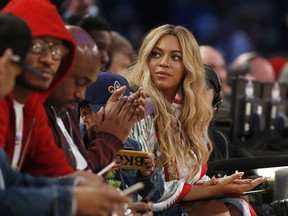 FILE - In this Feb. 19, 2017. file photo, Beyonce sits at court side during the second half of the NBA All-Star basketball game in New Orleans. Netflix on Sunday, April 7, 2019 posted on its social media channels a yellow image with the word "Homecoming" across it. The only other information was a date: April 17. That's when Netflix is expected to premiere a Beyonce special that may feature her performances at last year's Coachella Valley Music and Arts Festival.