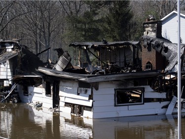 A home that caught fire is seen among floodwaters on Bayview Drive in the Ottawa community of Constance Bay, during a guided tour of Canadian Armed Forces flood relief operations in the National Capital Region on Tuesday, April 30, 2019.