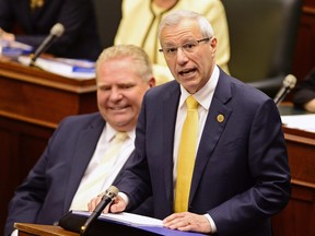 Ontario Finance Minister Vic Fedeli presents the 2019 budget as Premier Doug Ford looks on at the legislature in Toronto on Thursday, April 11, 2019.