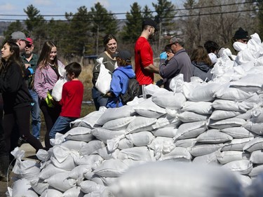 Students from Terry Fox Elementary School join fellow volunteers as they form a sand bag assembly line as the fight to hold back floodwaters on the Ottawa River continue in Cumberland, Ontario on Tuesday, April 30, 2019.