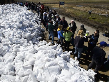 Students from Terry Fox Elementary School join fellow volunteers as they form a sand bag assembly line as they fight to hold back floodwaters on the Ottawa River continue in Cumberland, Ontario on Tuesday, April 30, 2019.