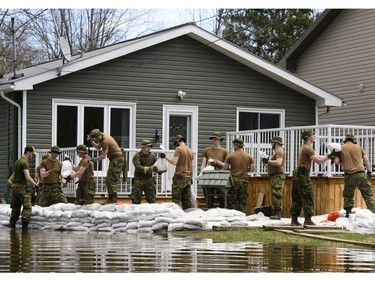 Soldiers work to hold back floodwaters on the Ottawa River in Cumberland. Ontario on Tuesday, April 30, 2019.