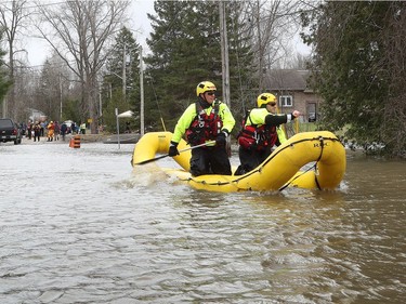 Ottawa fire fighters check homes for residence near Armstrong Road in Cumberland Saturday April 27, 2019.