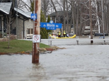 Ottawa fire fighters check homes for residence near Morin Road in Cumberland Saturday April 27, 2019.