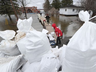 Volunteers help with sand bags on East Shore Road in Cumberland Saturday April 27, 2019.