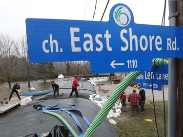 Volunteers help with sand bags on East Shore Road in Cumberland Saturday April 27, 2019.