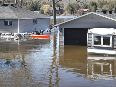 Media traveling with the Canadian Armed Forces during a flooding tour of Constance Bay in Ottawa Tuesday April 30, 2019. Members got a opportunity to watch the Canadian Armed Forces flood relief operations Tuesday. A man tries to sandbag his flooding home.