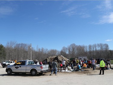 Residents and volunteers fill sand bags at the community centre in Constance Bay in Ottawa Tuesday April 30, 2019.