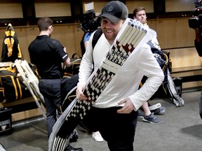 Pittsburgh Penguins forward Phil Kessel carries sticks and equipment from the practice facility locker room before leaving for the off season two days after being swept by the New York Islanders Thursday, April 18, 2019. (AP Photo/Keith Srakocic)