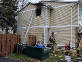 Firefighters clean up the scene opf a bathroom fire on Pintail Terrace,