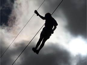 File photo: A person slides on a zip line.
