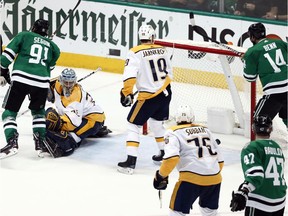 Dallas Stars' Tyler Seguin (91), Nashville Predators goaltender Pekka Rinne, Calle Jarnkrok (19), P.K. Subban (76), the Stars' Alexander Radulov (47) and Jamie Benn (14) watch as the puck falls out of the back of the net on a John Klingberg score in overtime of Game 6 of an NHL hockey first-round playoff series in Dallas, Monday, April 22, 2019. The Stars won 2-1 in overtime.