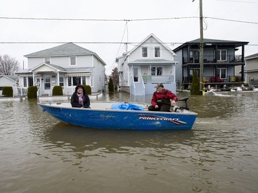 Residents use a boat to make their way along Rue Jacques-Cartier in Gatineau, Que. as flooding from the Ottawa River continues to affect the region on Saturday, April 27, 2019.