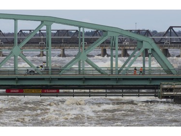 City workers inspect an interprovincial bridge between Ottawa and Gatineau, Que., Sunday, April 28, 2019. The bridge was closed to pedestrian and vehicle traffic due to high waters.