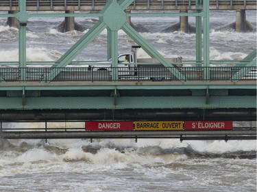 A city vehicle drives across an interprovincial bridge between Ottawa and Gatineau, Que., Sunday, April 28, 2019. The bridge was closed to pedestrian and vehicle traffic due to high waters.