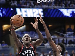 The Toronto Raptors' Pascal Siakam (43) shoots against the Orlando Magic's Jonathan Isaac during the first half in Game 3 on Friday, April 19, 2019, in Orlando.