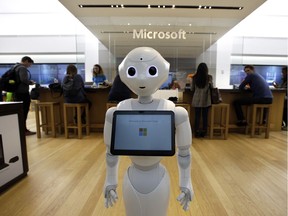 In this March 21, 2019 photo a robot called "Pepper" is positioned near an entrance to a Microsoft Store location, in Boston.
