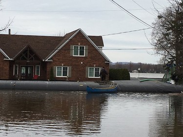 Residents on Leo Lane in Cumberland canoes to dike around home