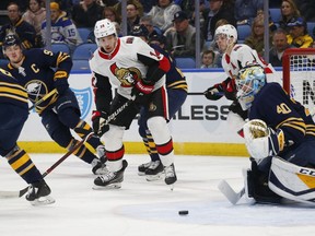 Buffalo Sabres goalie Carter Hutton and Ottawa Senators forward Max Veronneau watch the puck during the second period on Thursday, April 4, 2019, in Buffalo, N.Y.