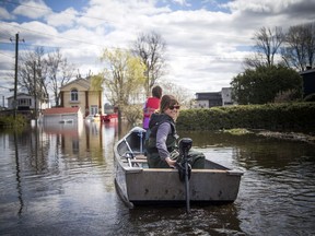 The water levels were rising in Ottawa and Gatineau along the rivers Saturday May 11, 2019. Jennifer Hunnisett and her daughter nine-year-old Audrey Pham-Dinh make their way back to their home on Boulevard Hurtubise, where they plan to spend the weekend camping to celebrate Mothers Day together with their dog Nelly.