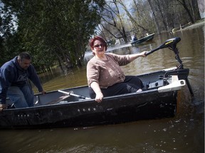 The water levels were rising in Ottawa and Gatineau along the rivers Saturday May 11, 2019. Helen Theoret and her son Charles Theoret leave in her boat with a few items she came home to retrieve on Boulevard Hurtubise. Her and her husband had to leave their home.