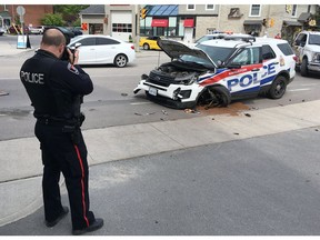 Kingston Police investigate a three-vehicle collision at Princess and Victoria streets in Kingston, Ont., on Thursday, May 30.